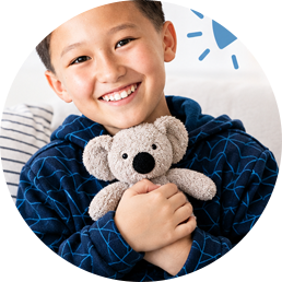 A child hugging Ollie the koala